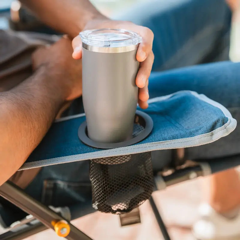 Close-up of gray tumbler placed in the mesh cupholder of the heathered indigo Kickback Rocker.