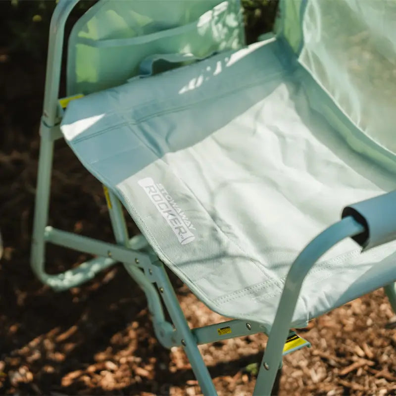 Close-up of pastel green Stowaway Rocker seat with “Stowaway Rocker” text on the edge.