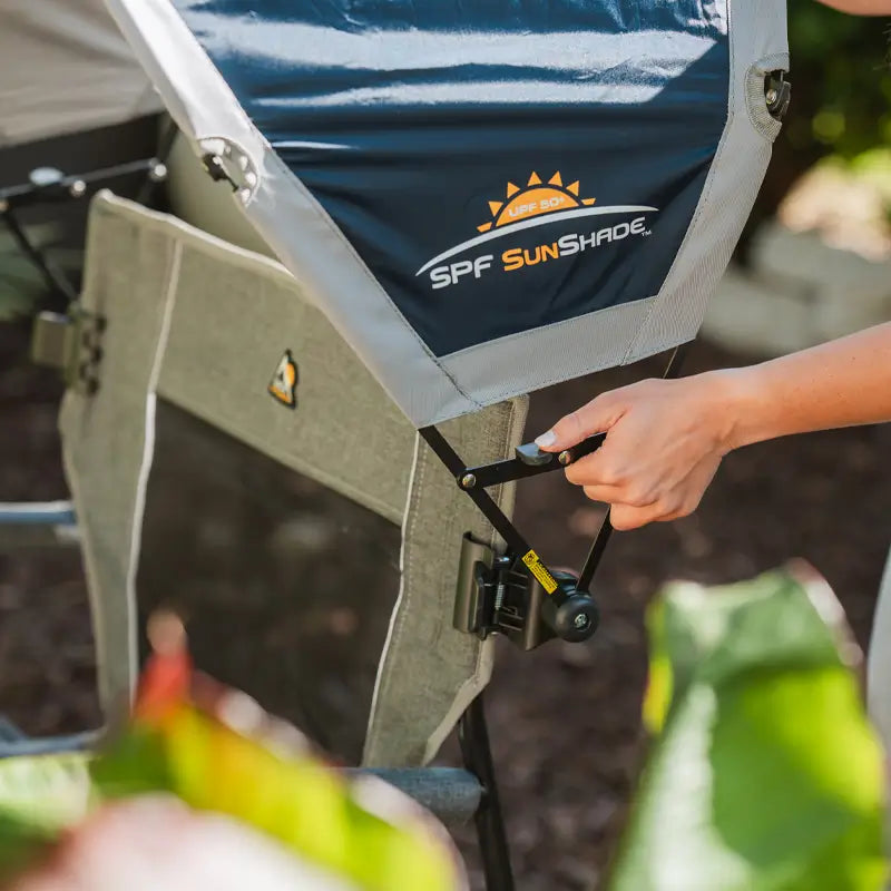 Close-up of Indigo SunShade being attached to a grey chair using a clamp mechanism.
