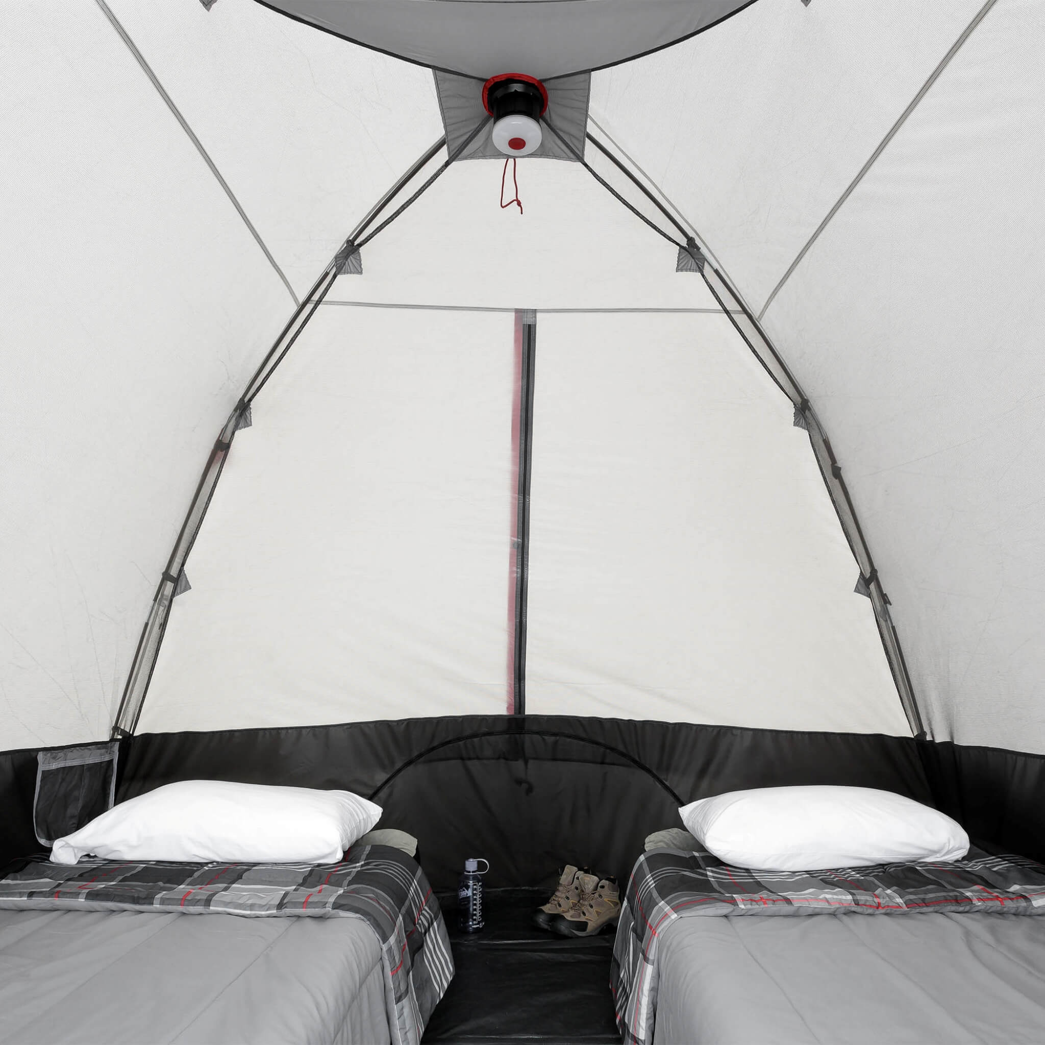 Inside CORE 6 person lighted dome tent with two cots in spacious sleeping setup.