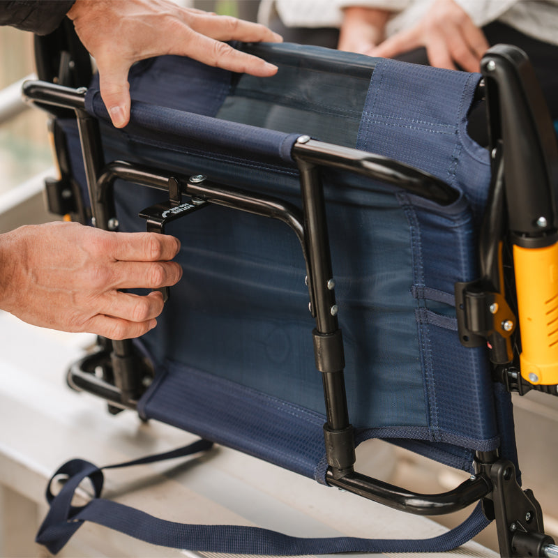 Hands adjusting l-hook on rich blue Stadium Rock-Cliner under bleacher seat.