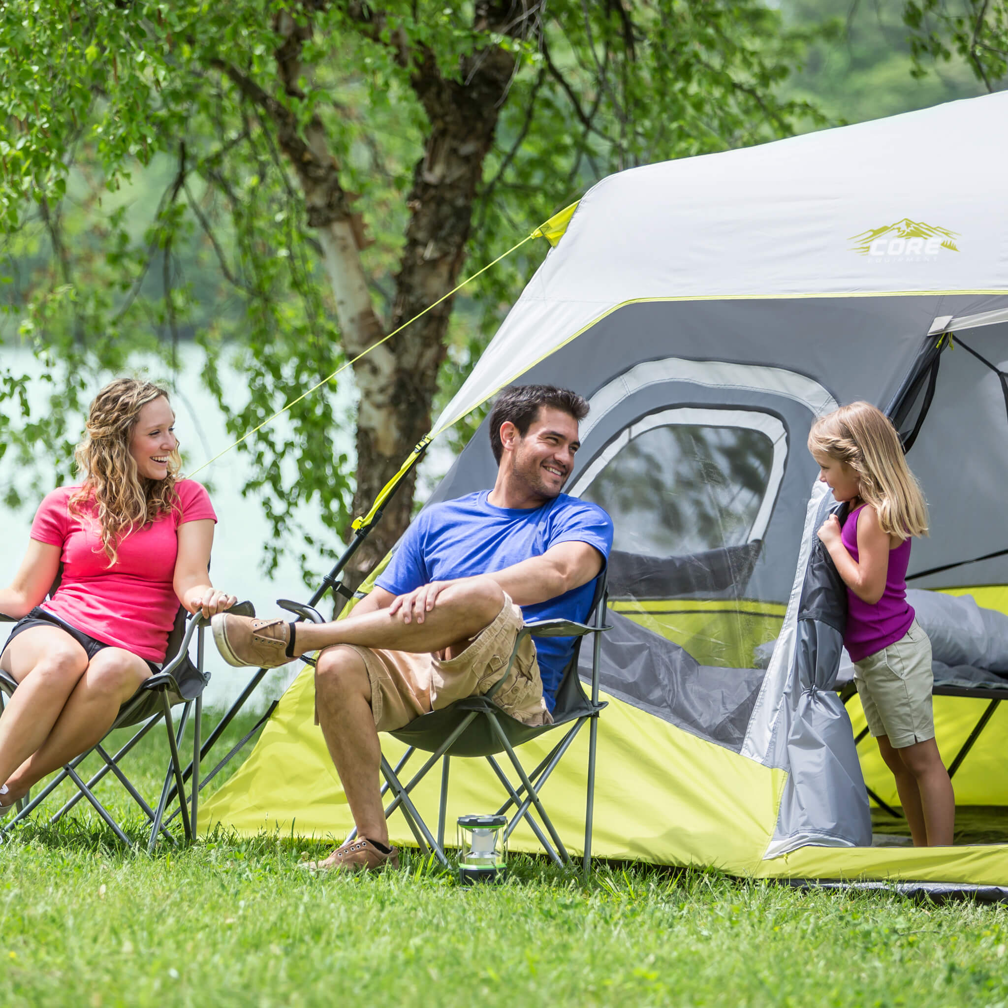 Family enjoying time outside the CORE 6 person instant cabin tent in gray and green, offering durable weather protection and comfort.